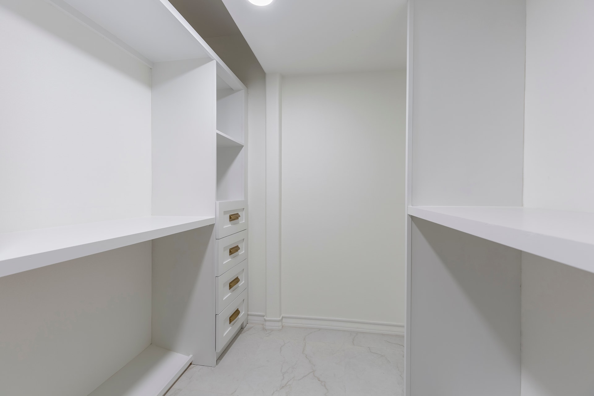 Modern white walk-in closet with shelving