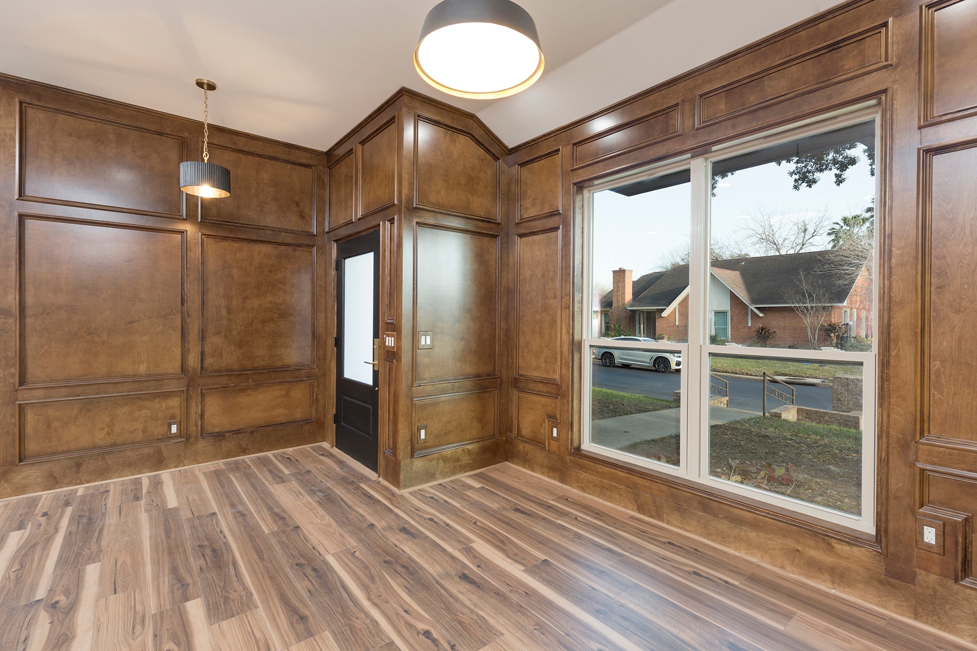 Luxury home office wood paneling large windows
