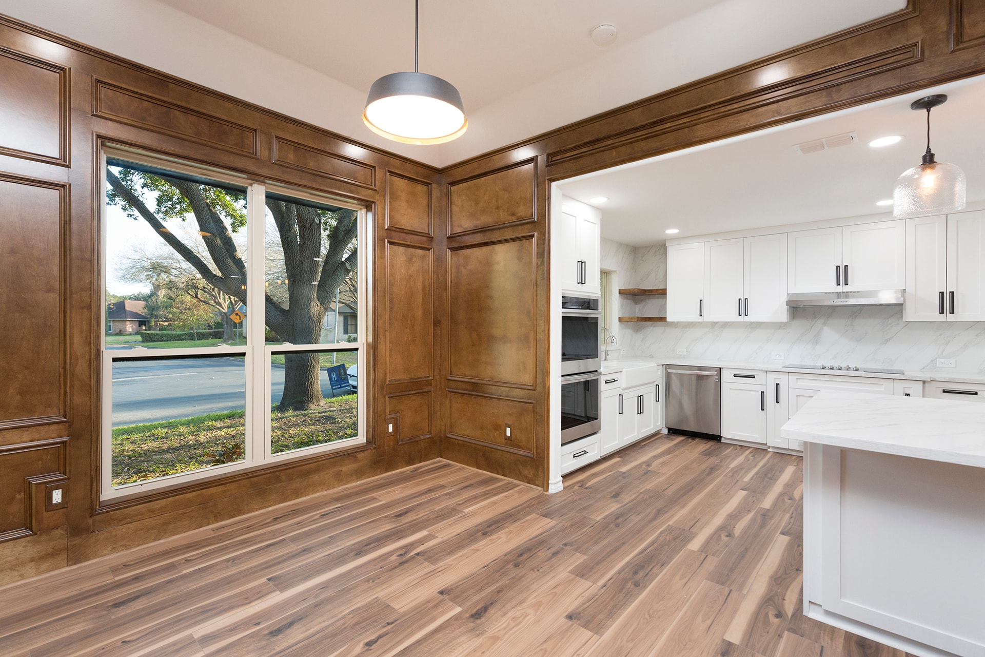 Modern kitchen with wood paneling and white cabinets