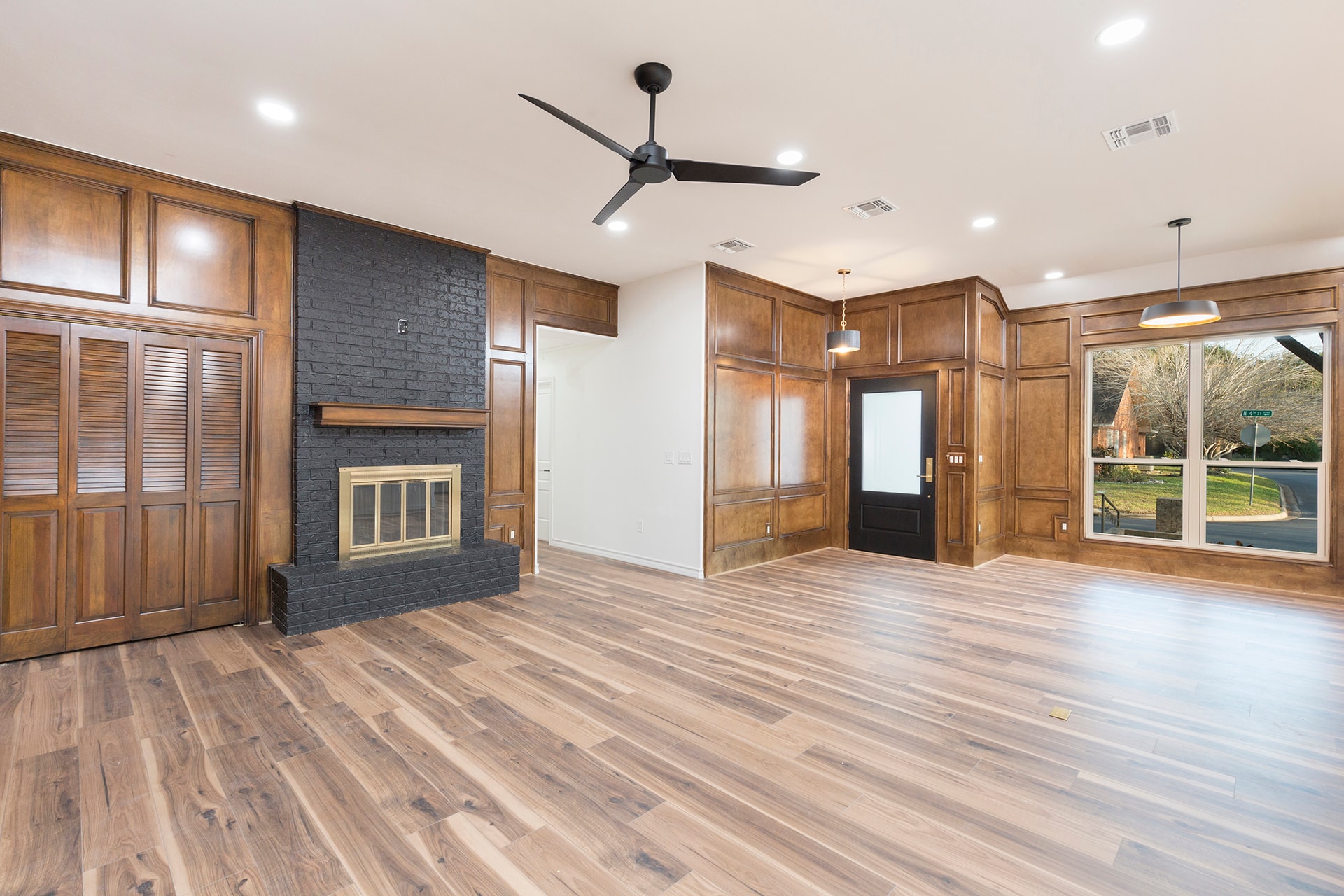 Modern living room with fireplace and wood paneling