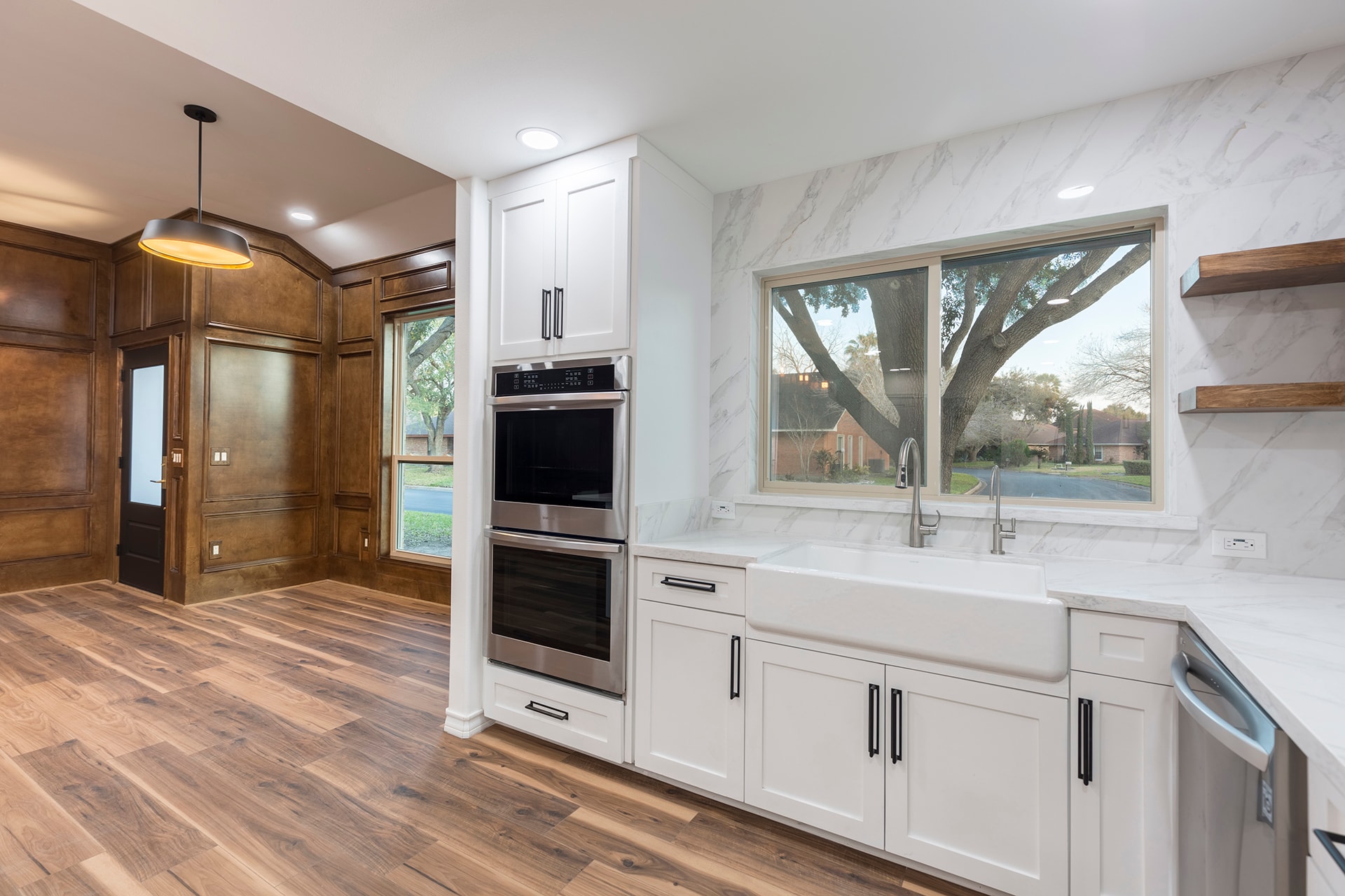 Modern kitchen with white cabinets and marble backsplash