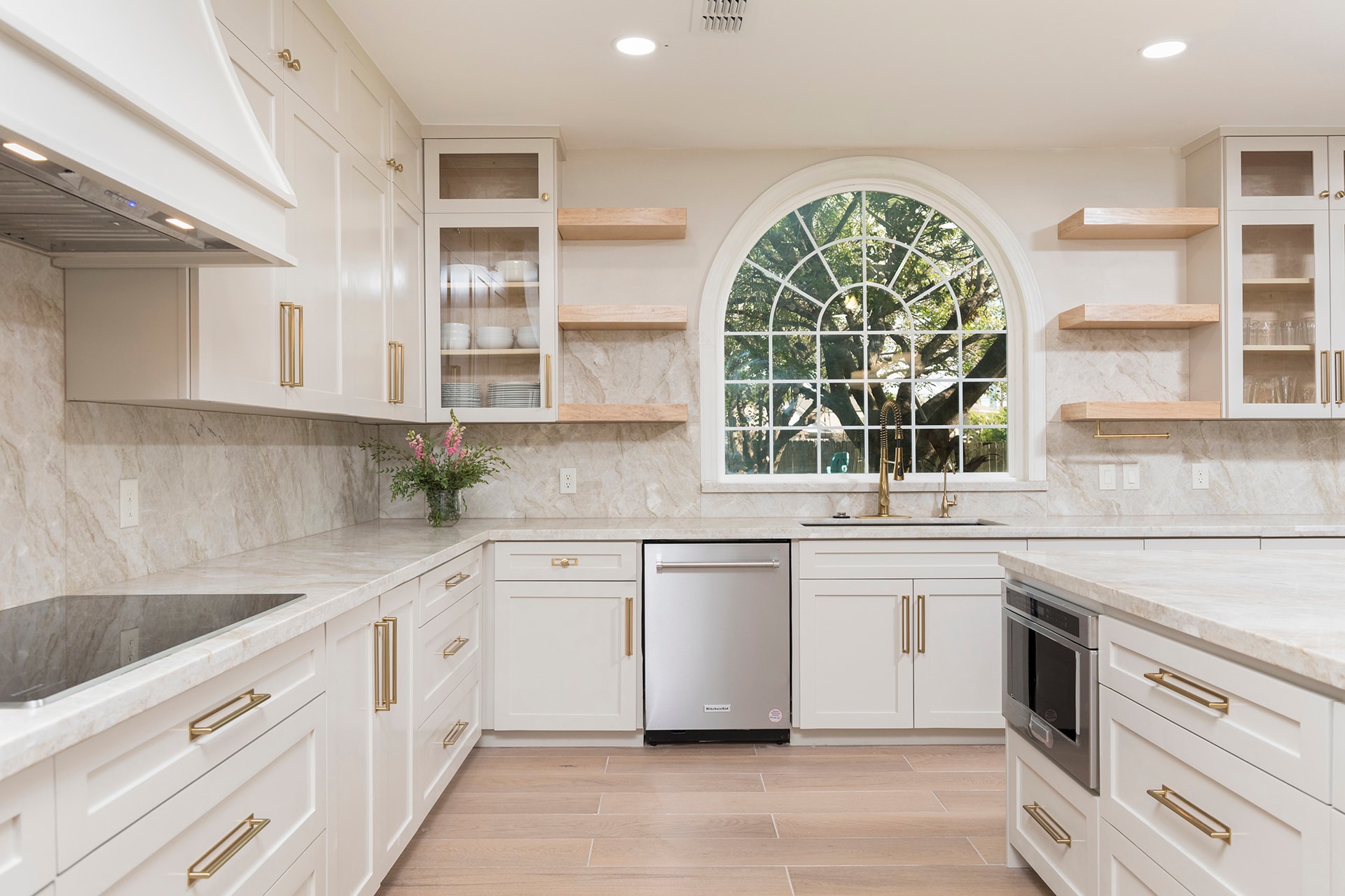 Modern white kitchen with arched window and open shelving