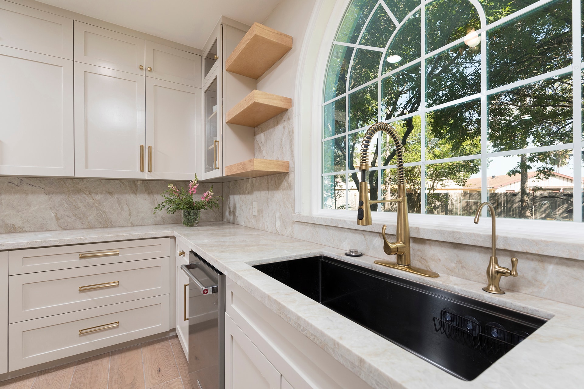 Modern kitchen sink with black farmhouse sink and brass faucet