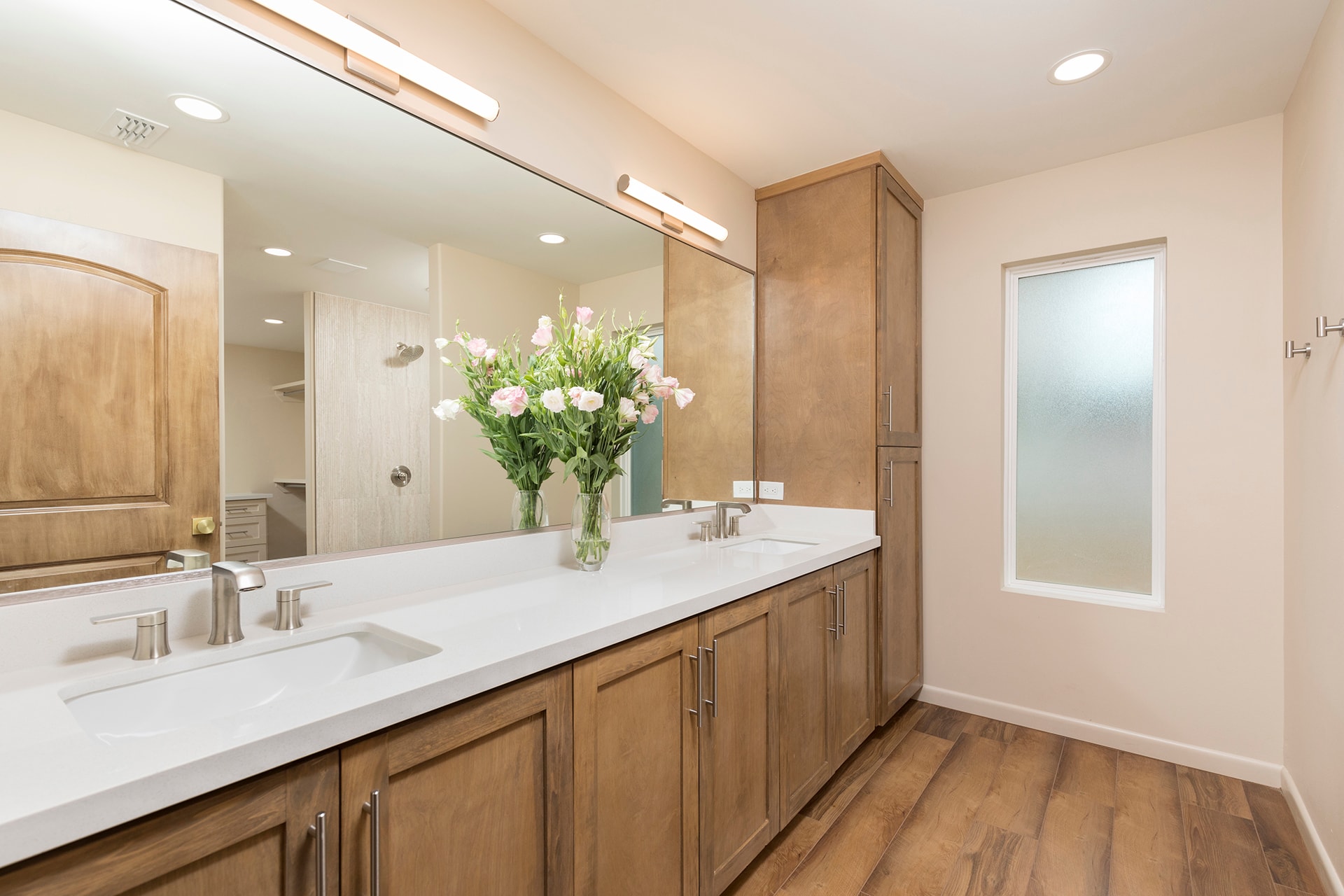 Modern bathroom with wood cabinetry and flowers