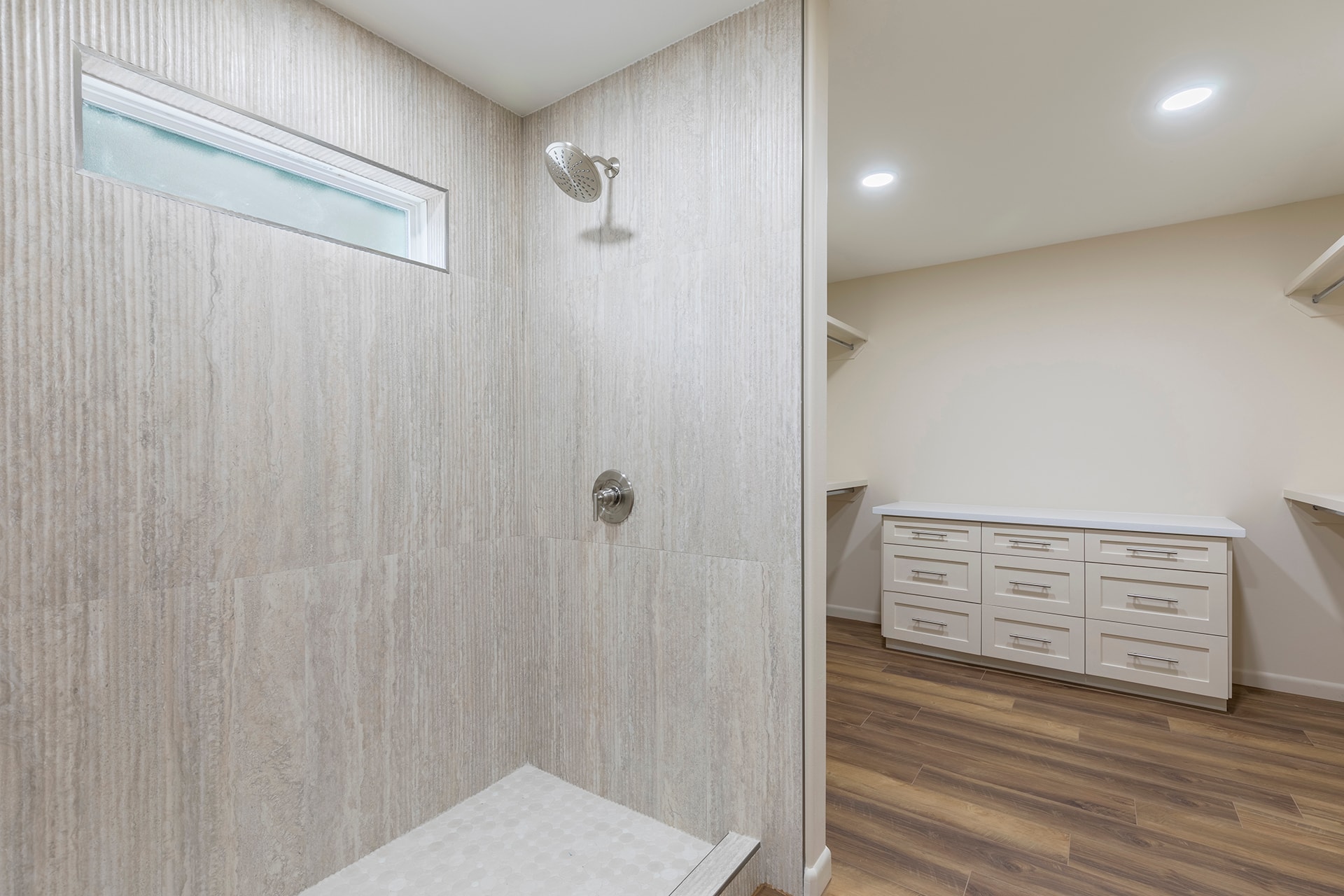 Modern bathroom with walk-in shower and dresser