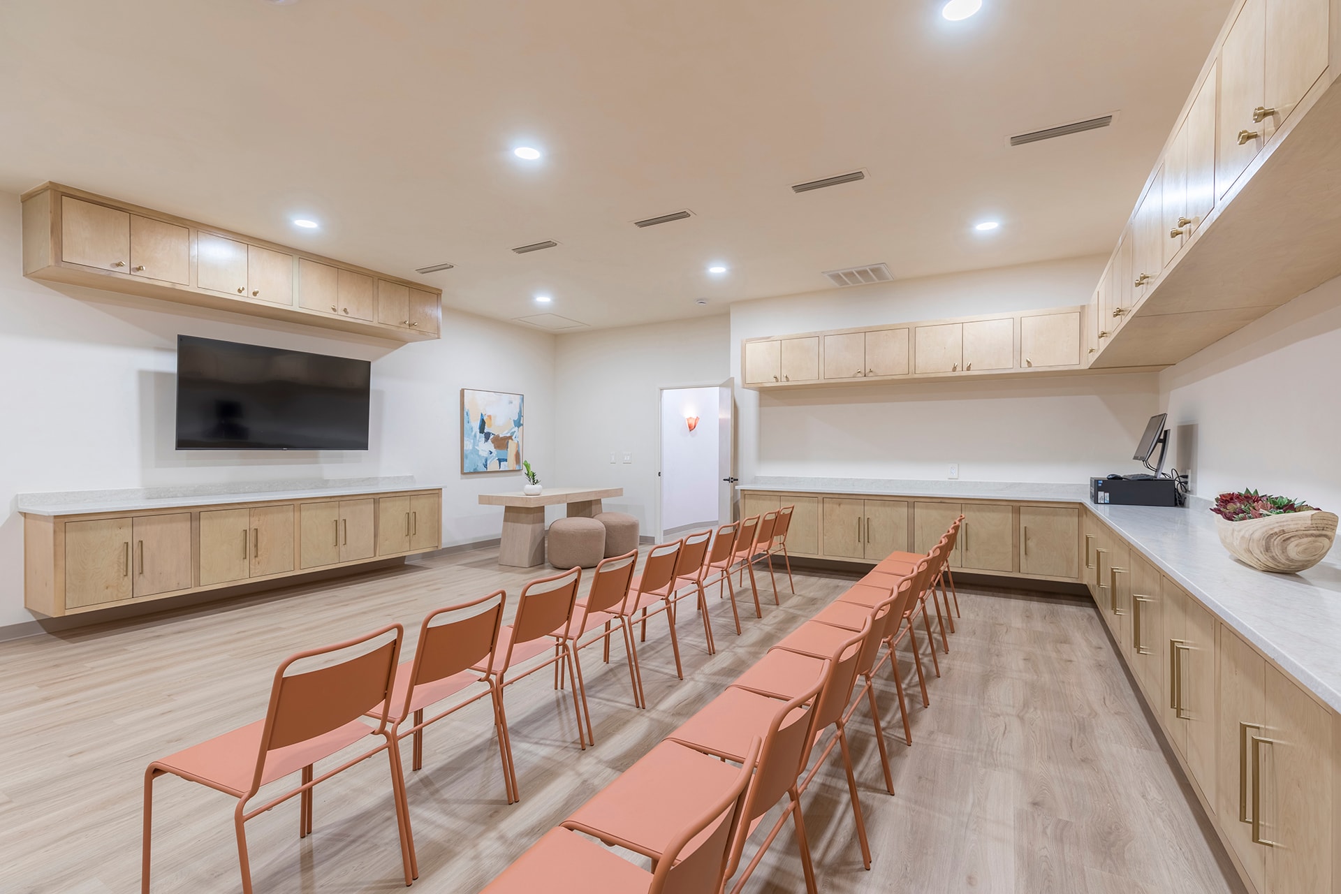 Modern community room with orange chairs