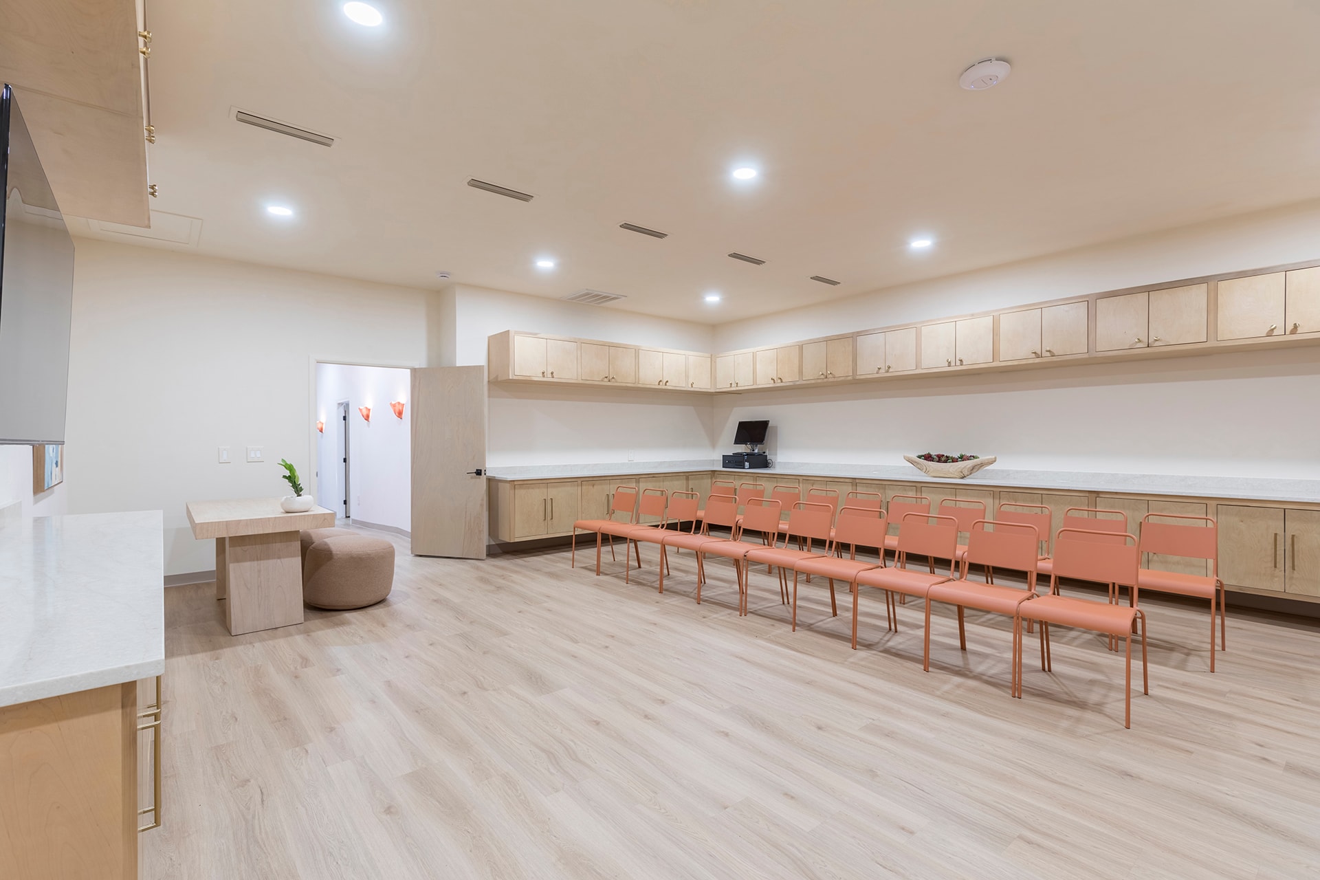 Modern kitchen with rows of orange chairs