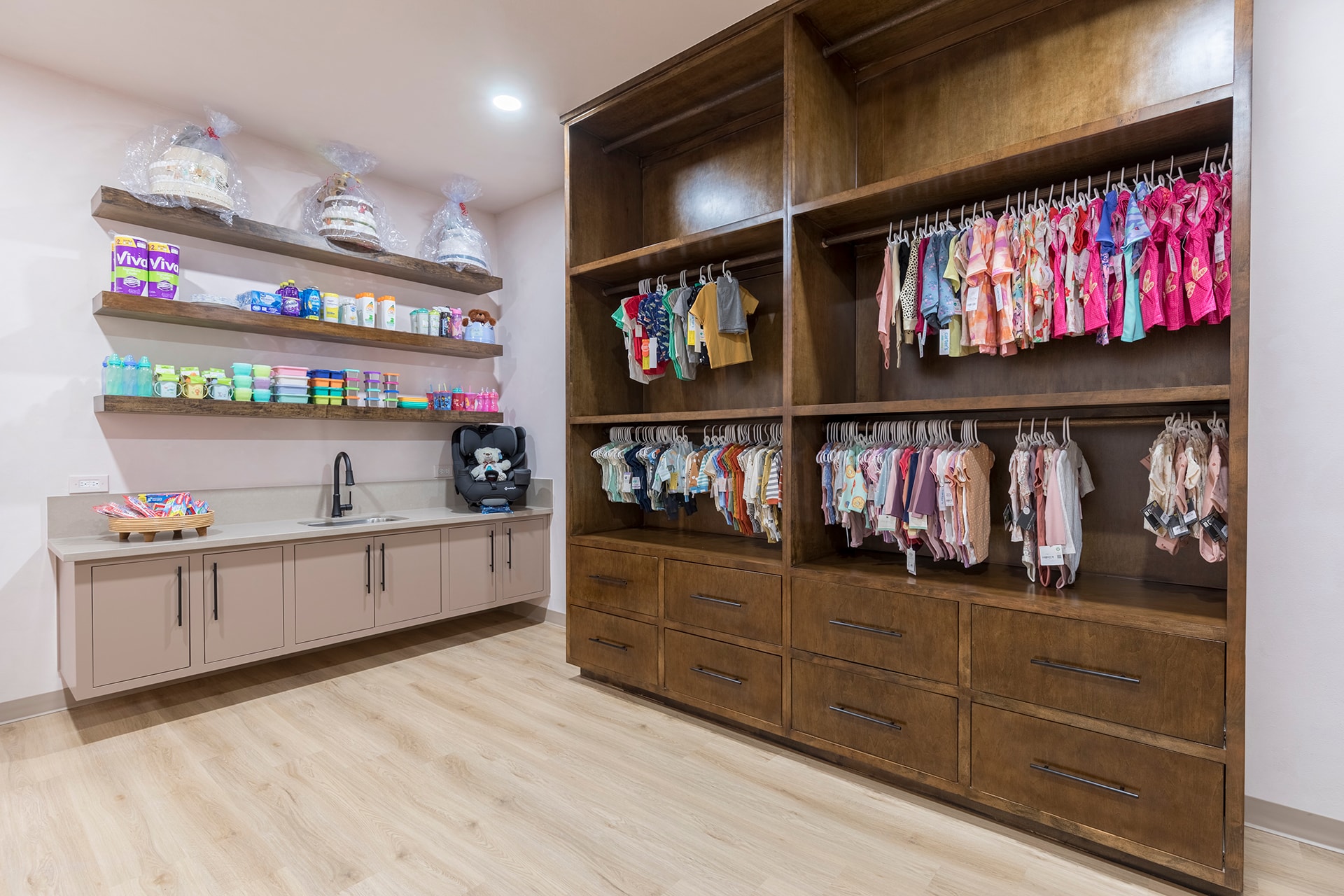 Organized baby clothing and supplies storage room