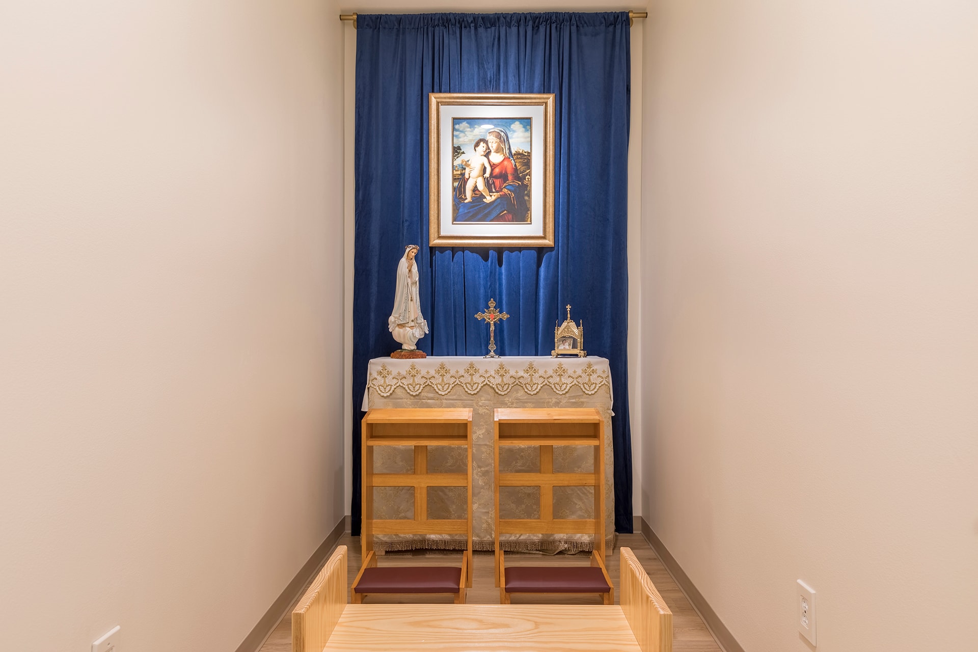 Religious altar with framed artwork blue curtain