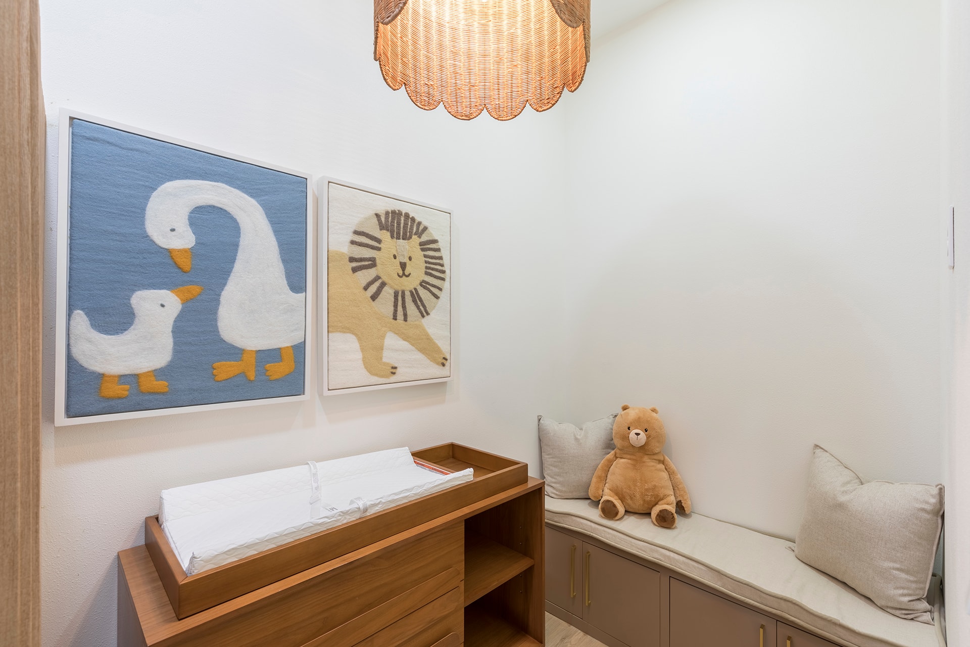 Modern nursery with animal artwork and teddy bear