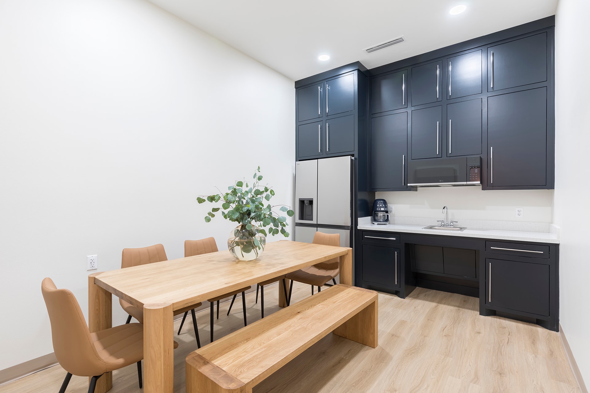 Modern kitchen dining area with black cabinets