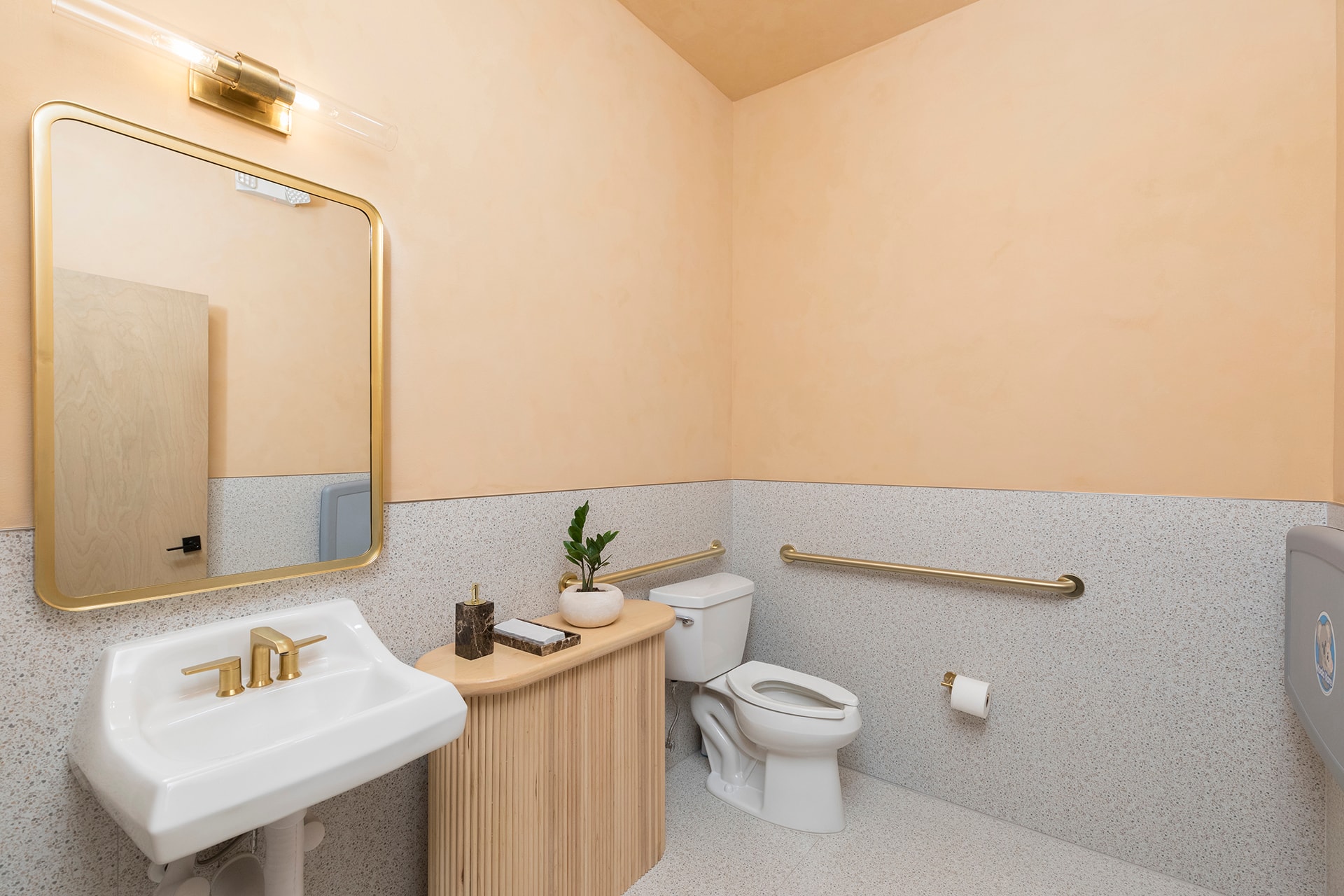 Modern bathroom with gold fixtures and accessories