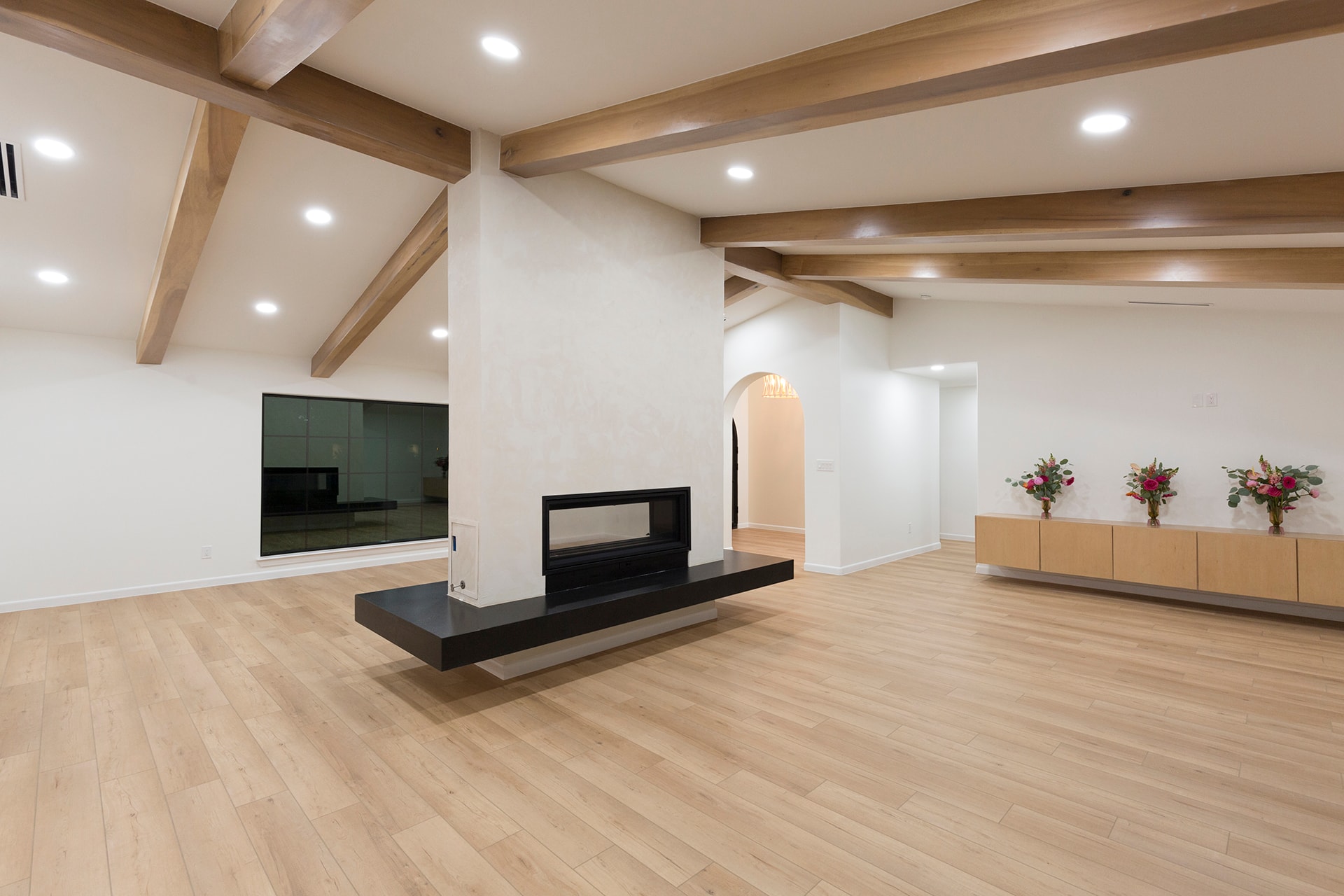Modern living room with fireplace and wood beams