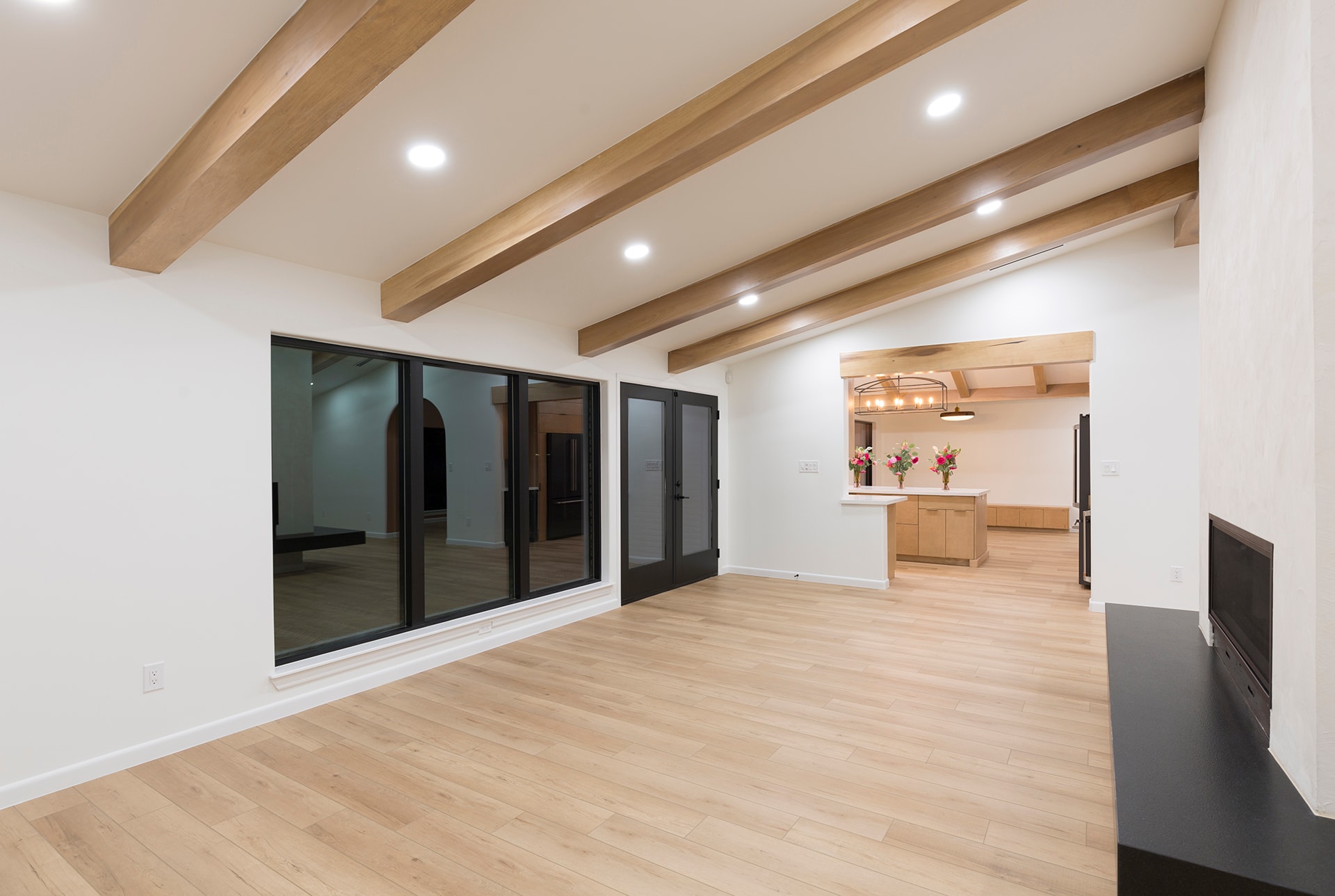 Modern open concept living space wooden beams