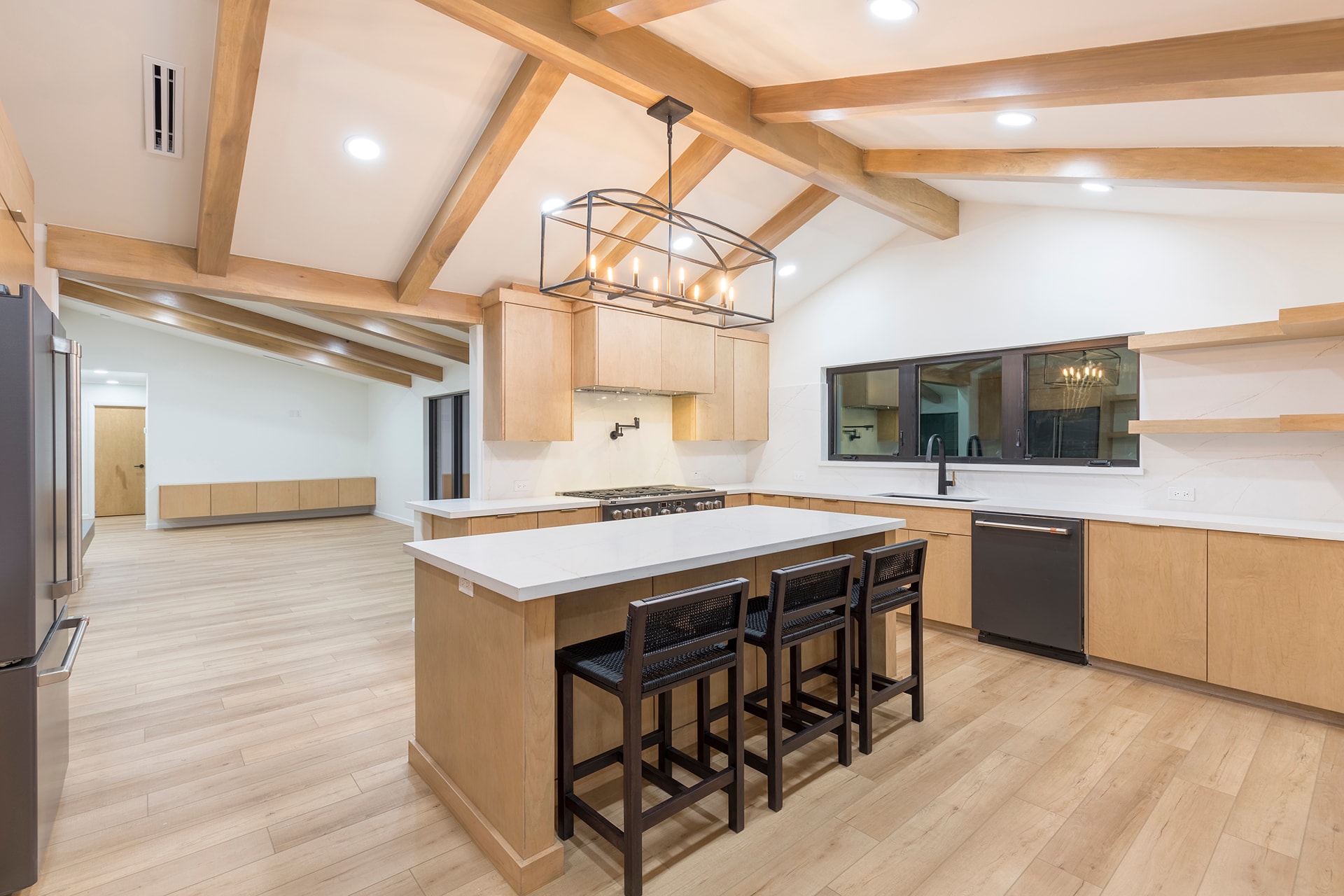 Modern kitchen with wood beams and island seating