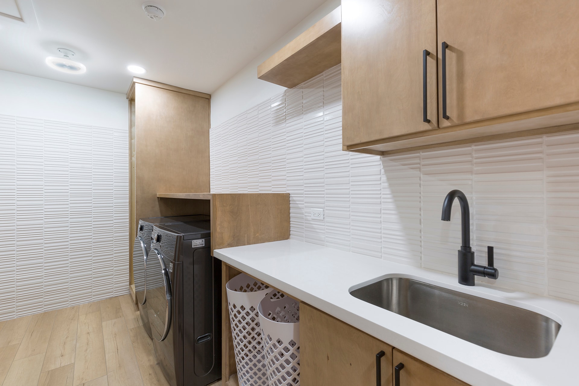 Modern laundry room with white tile backsplash