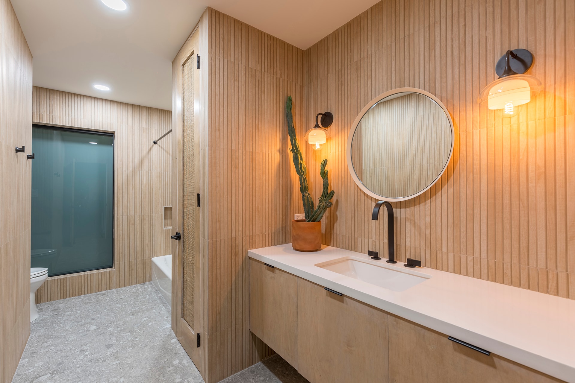 Modern bathroom with wood paneling and cactus