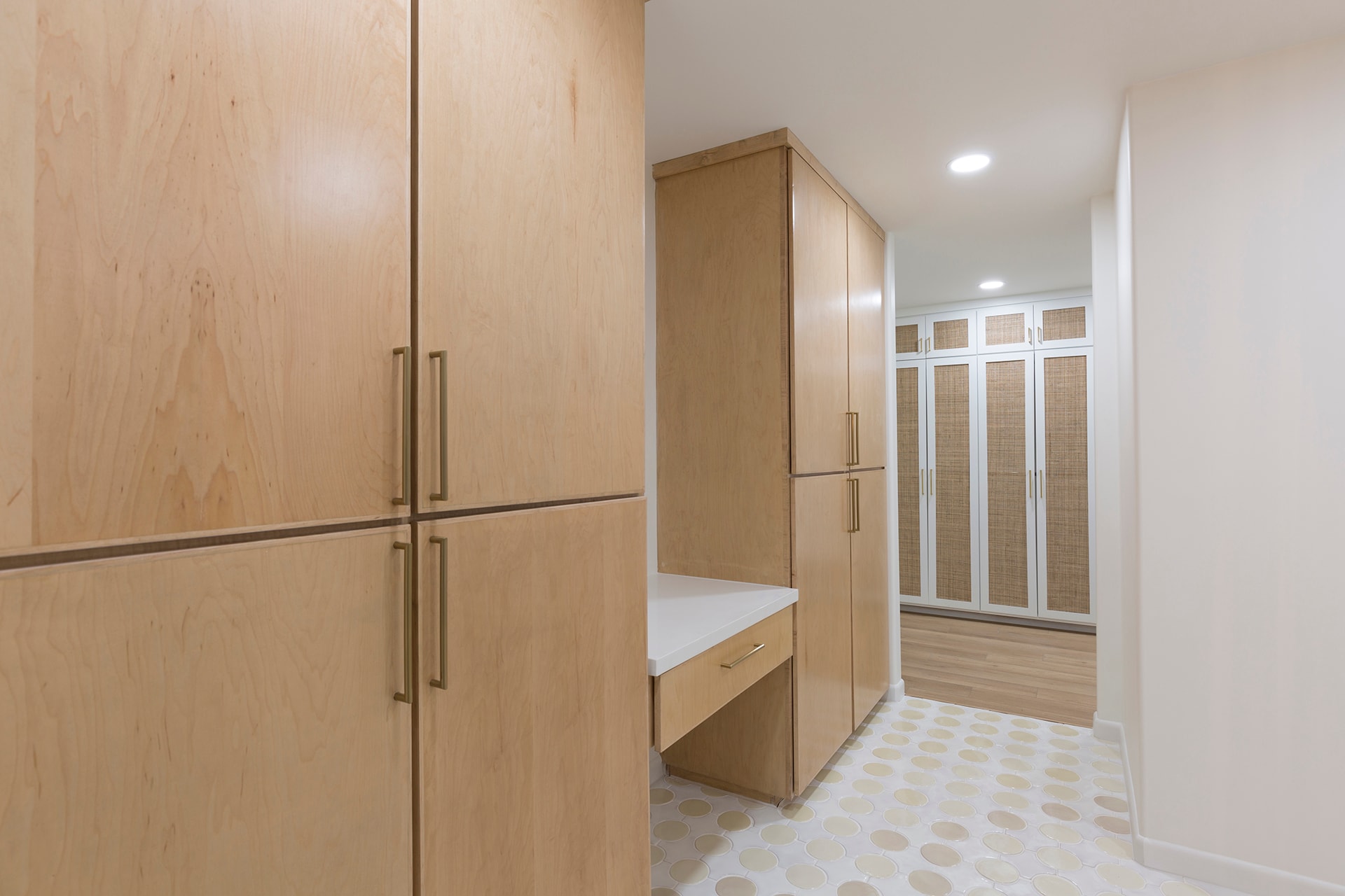 Modern walk-in closet with wood cabinetry