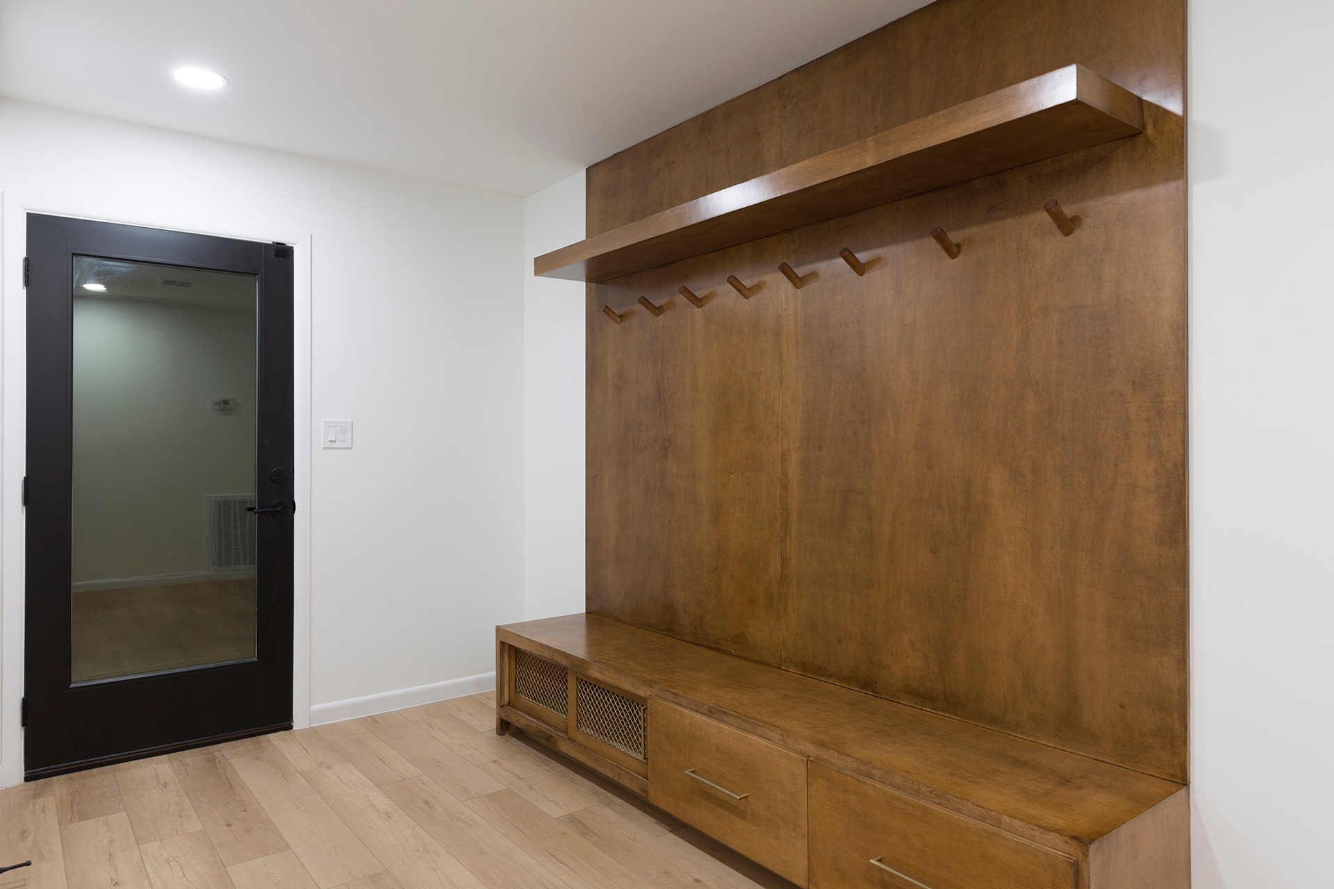 Modern entryway with wooden built-in mudroom