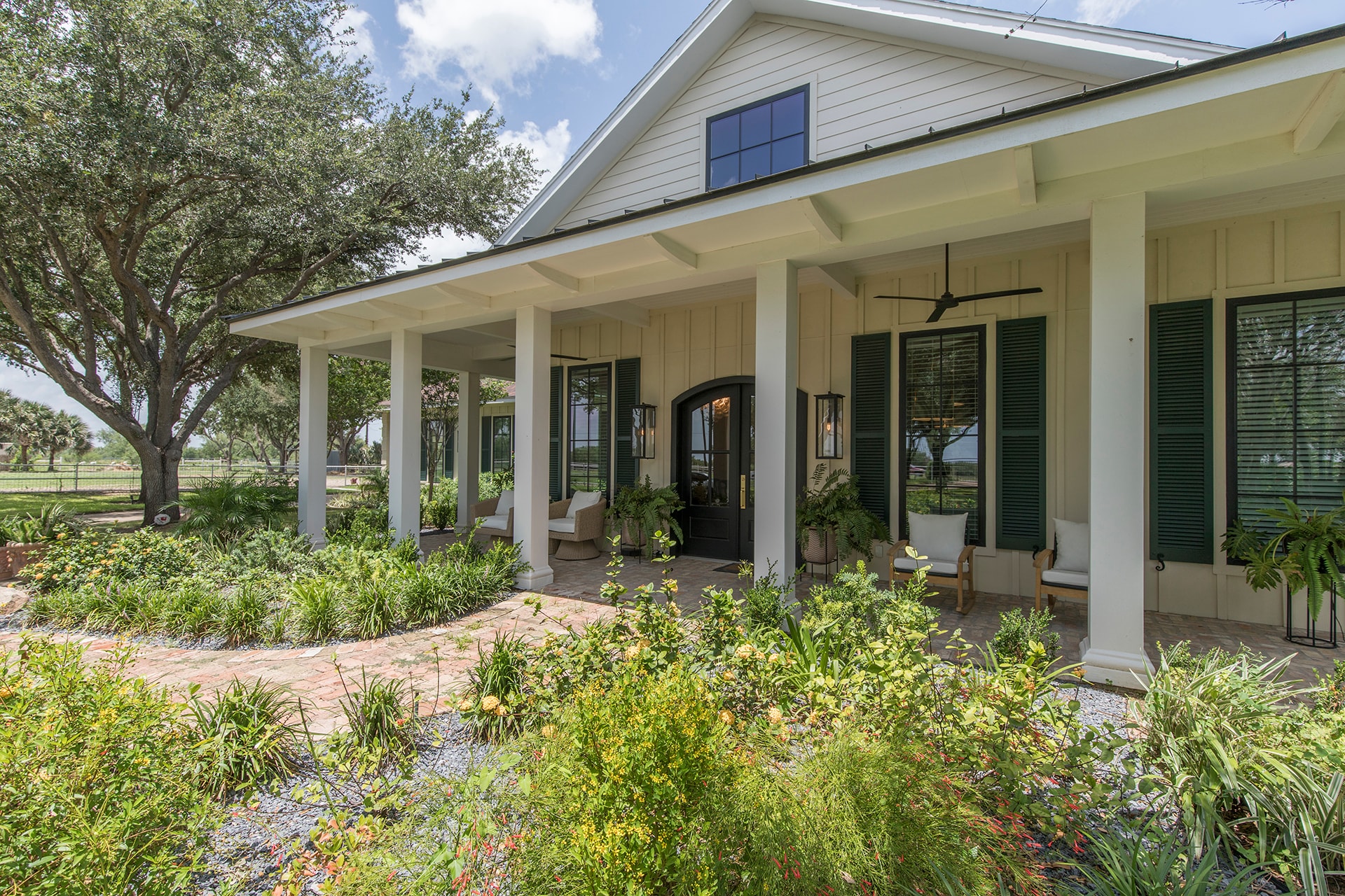 Modern farmhouse porch with landscaped garden