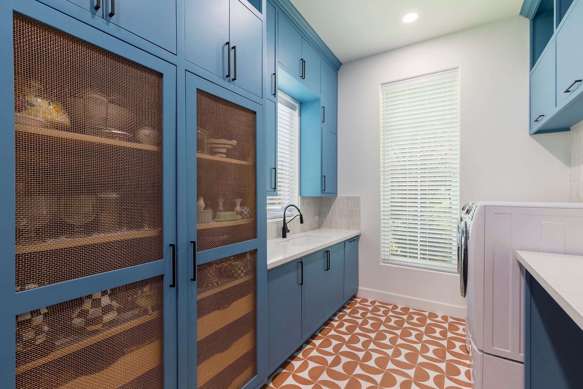 Modern laundry room blue cabinetry mesh doors