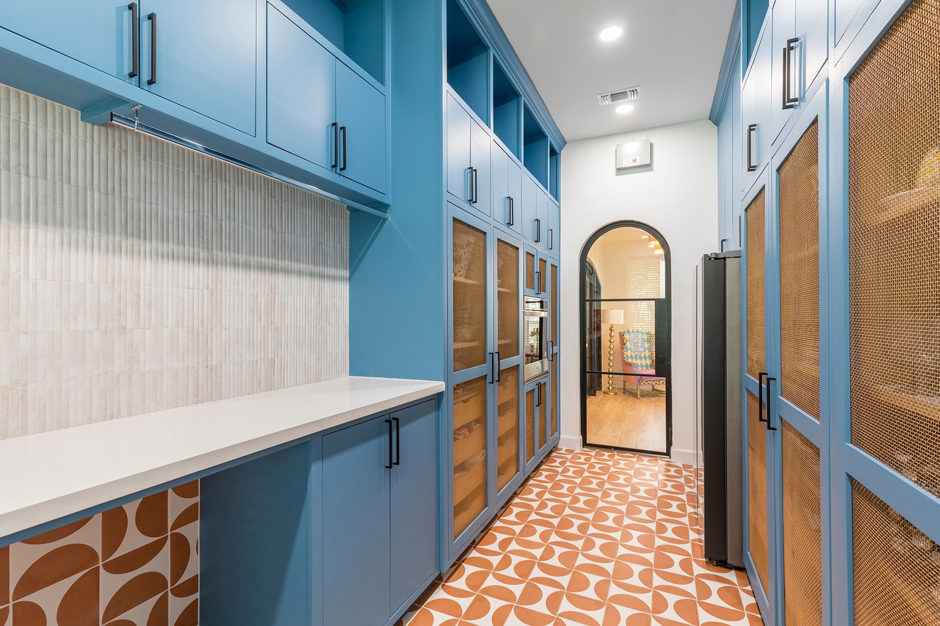 Modern kitchen with blue cabinetry and geometric tile